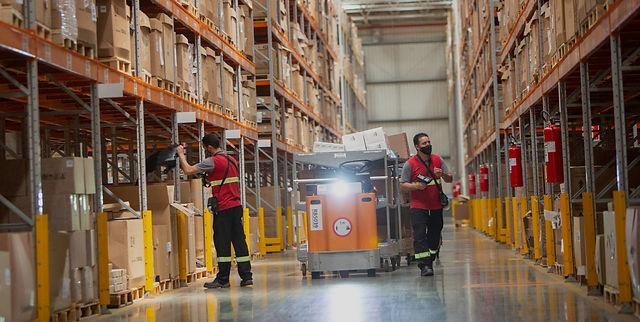Warehouse operators moving goods inside a distribution centre